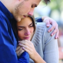 Man comforting his sad mourning friend