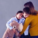 Sad little children, boys, hugging their mother at home, isolated image, copy space. Family concept